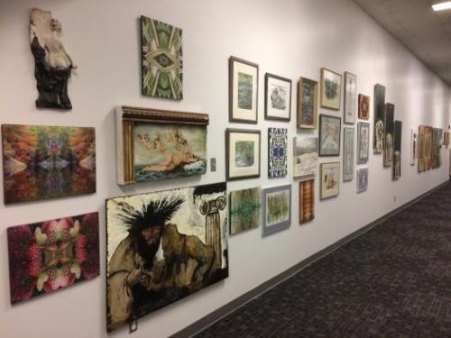A variety of artwork displayed in a hallway