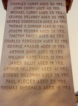 : A close-up colour photograph of some of the names on a miners’ monument in New Waterford, taken in 1977.