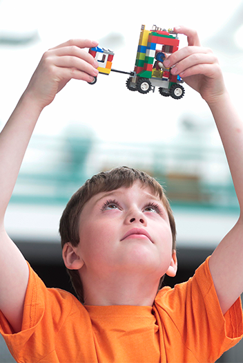 Image of a boy playing with LEGO.