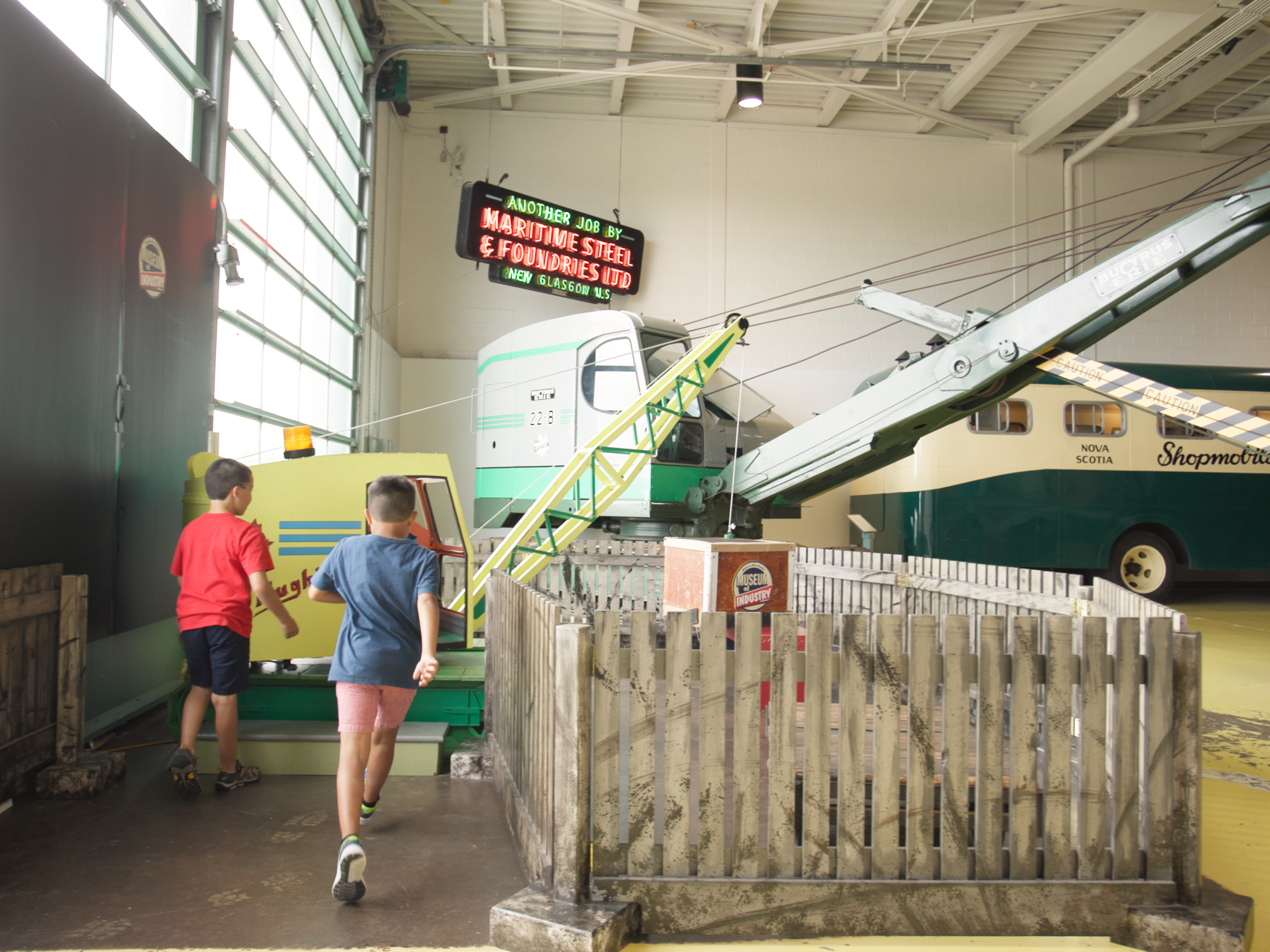 Kids exploring Hughie the crane