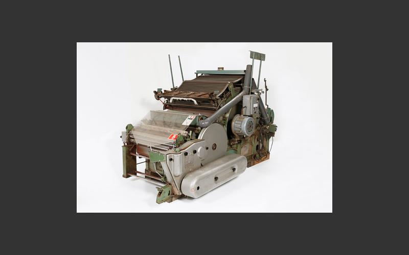 Carding machine for cotton from Dominion Textiles in Yarmouth. Part of the process of changing raw cotton into cloth, the carder uses bristled rollers to align the fibres to make the material ready for spinning.