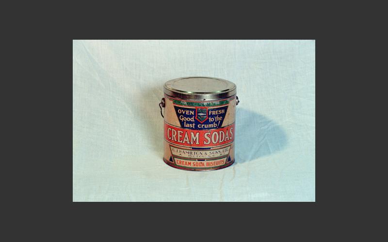 A tin for cream soda biscuits, one of 300 kinds made by G.J. Hamilton Bakery, Pictou. This large industrial bakery started in 1840 and by 1900 it was the largest and most modern biscuit factory in the region, shipping biscuits and confectionery as far as the West Indies.