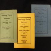 Various union agreements. These small booklets were distributed to all union members so that they would have access to information about their rights under the agreement.