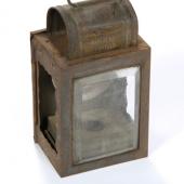 A candle lamp: this was the lighting used in the mines before the development of enclosed kerosene lamps.