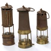 Three kerosene safety lamps. These lamps provided light and also monitored air quality. Their development began in the early nineteenth century and they were in use into the early twentieth century, gradually replaced by electric lights.
