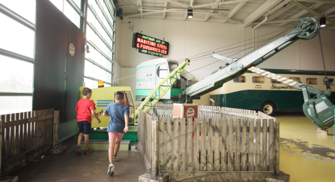 Kids exploring Hughie the crane