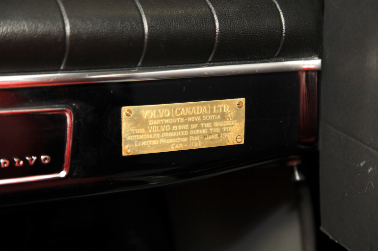Volvo Canadian, red leather interior. interior detail plaque